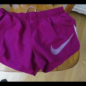Fuschia colored nike running shorts
